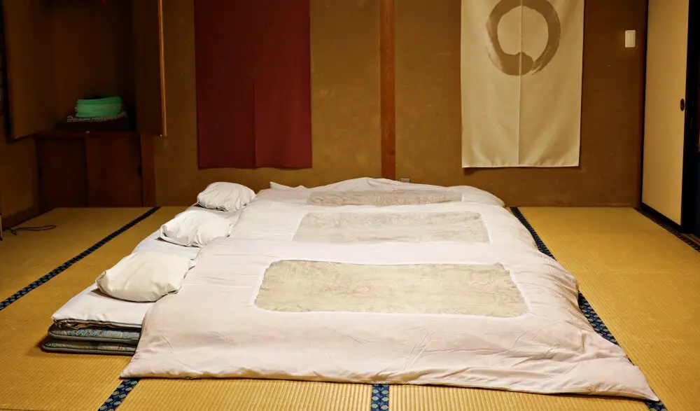 Ryokan futons laid out on tatami mat floor