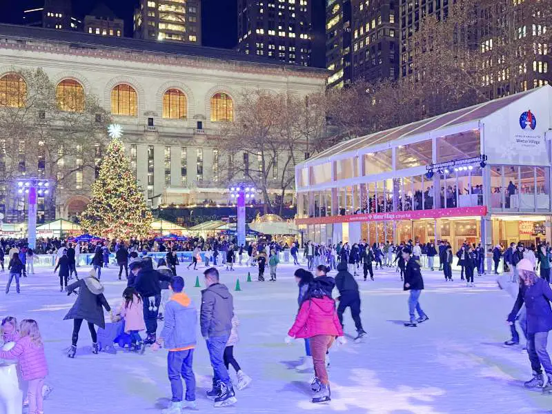 skaters with christmas teee and back of library behind