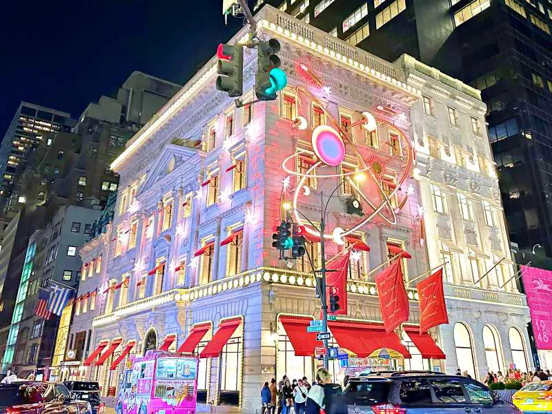 corner building white with yelllow lights and red decorations like moon and stars