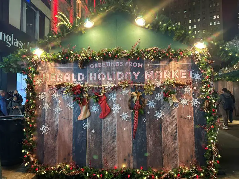 wooden end with green roof of temporary stalls for holiday market