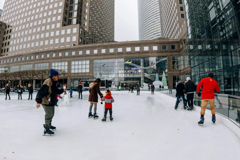 people ice skating with building around them at the Rink at Brookfield Place in NYC