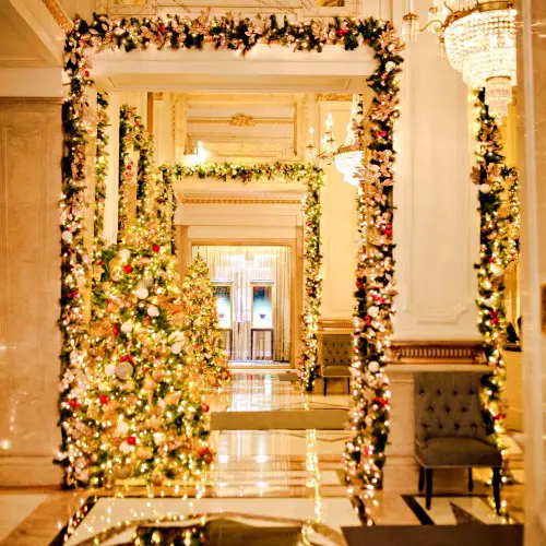 hallway with series of doorways decorated around the edges with christmas lights